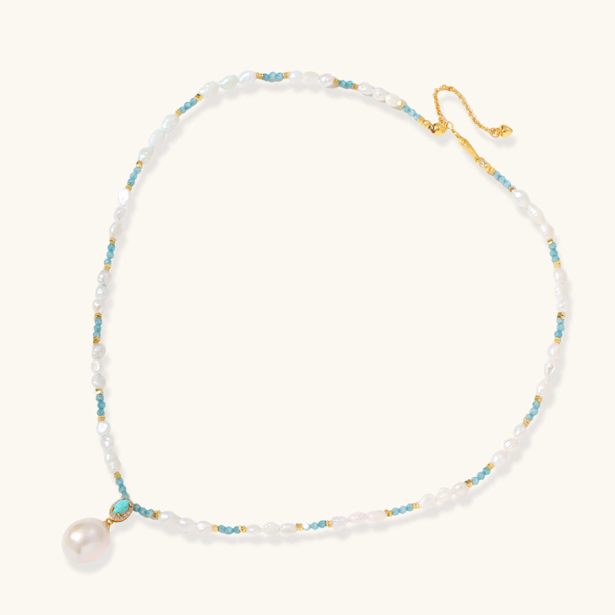 Beaded necklace with baroque pearls, turquoise stones, and gold accents featuring a large pearl pendant on white background.
