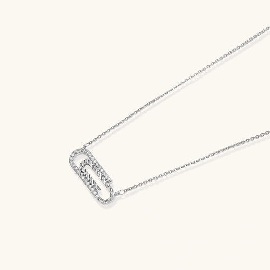 White gold plated necklace with dual-frame geometric pendant featuring crystal pavΓ© border on pale background.