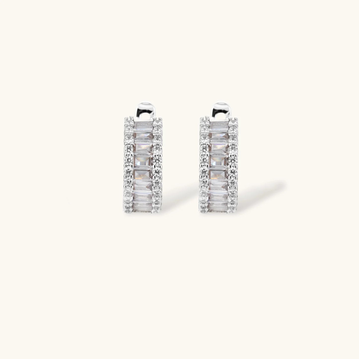 White gold plated necklace with vertical cubic zirconia pendant and matching hoop earrings on neutral background
