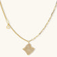 Gold-plated wavy jewelry set with crystal detailing featuring necklace with dual chains and matching textured earrings