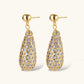 Gold-plated teardrop necklace and earrings covered in AAA cubic zirconia crystals on cream background.