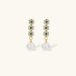 Gold-plated jewelry set with green cubic zirconia floral motifs, featuring matching necklace and pearl drop earrings