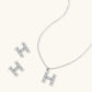 Letter H jewelry set featuring geometric crystal design in gold and white gold plated finish with adjustable chain necklace
