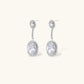 Elegant white gold plated jewelry set with oval cubic zirconia stones in halo settings, featuring Y-necklace and drop earrings.