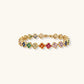 Colorful four-leaf clover jewelry set with rainbow cubic zirconia stones in gold-plated setting on white background