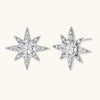 Sterling silver star-shaped stud earrings with brilliant moissanite center stones and pavé details on neutral background.