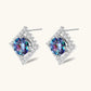 Diamond-shaped sterling silver stud earrings with rainbow moissanite centers surrounded by crystal halos