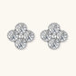 Dainty sterling silver quatrefoil stud earrings with four brilliant moissanite stones and center accent on white background.