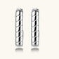 Close-up of platinum-plated sterling silver hoop earrings with horizontal textured grooves on white background.