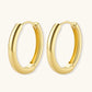 Polished gold-plated sterling silver hoop earrings with hinged closure mechanism on white background.