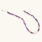 Beaded necklace with purple amethyst chips, freshwater pearls, and gold accents on white background.