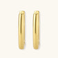 Polished gold-plated sterling silver hoop earrings with hinged closure mechanism on white background.