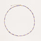 Delicate 18K gold vermeil necklace with alternating lavender zirconia beads and white freshwater pearls on cream background