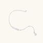 Minimalist bracelet with iridescent baroque pearl on rhodium-plated sterling silver chain against cream background