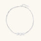 Sterling silver multi-strand necklace with three brushed round beads on cream background