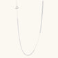 Long sterling silver beaded necklace with graduated sphere design, toggle clasp, and delicate chain extension on white background