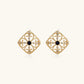 Gold filigree stud earrings with navy lapis lazuli center stone and mother-of-pearl accents in ornate quatrefoil design