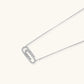White gold plated necklace with dual-frame geometric pendant featuring crystal pavé border on pale background.
