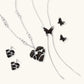 Dark wood butterfly earrings and necklace with silver chain accents on white background, showing natural grain texture.