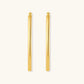 Set of geometric gold-plated sterling silver hoop earrings in oval and cushion shapes on cream background