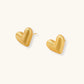 Pair of small heart-shaped stud earrings with brushed metallic finish, showing both silver and gold variants on neutral background.