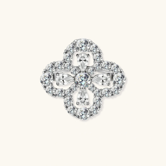 Adjustable sterling silver ring with quatrefoil design featuring brilliant moissanite stones in clover pattern