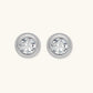 Close-up of sterling silver stud earrings featuring concentric circular frames with brilliant moissanite centers