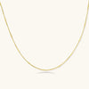 Delicate gold-plated sterling silver chain necklace with geometric segments displayed against cream background