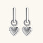Platinum-plated 925 sterling silver rectangular hoop earrings with twisted ring connector and ribbed heart charm pendant.