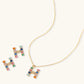 Gold-plated letter H jewelry set with multicolor zirconia stones in emerald cuts, showing necklace pendant and matching earrings