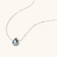 White gold plated spherical jewelry set with zirconia crystal pavé and dark lustrous centers on neutral background.