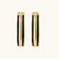 Modern hoop earrings with gold-plated and black sections, featuring hinged closure on white background.