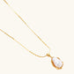 18K gold-plated sterling silver necklace with alternating bead chain and baroque pearl pendant on neutral background.