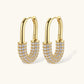 Gold-plated huggie hoop earrings with pavé zirconia stones covering the bottom curve, shown in open and closed positions.