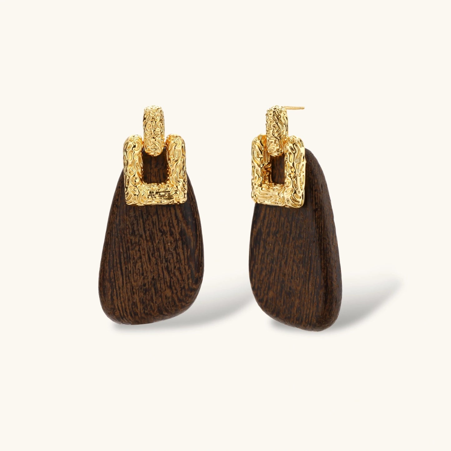 Elegant drop earrings featuring intricate 18k gold plated copper metalwork with dark brown wooden teardrop pendants