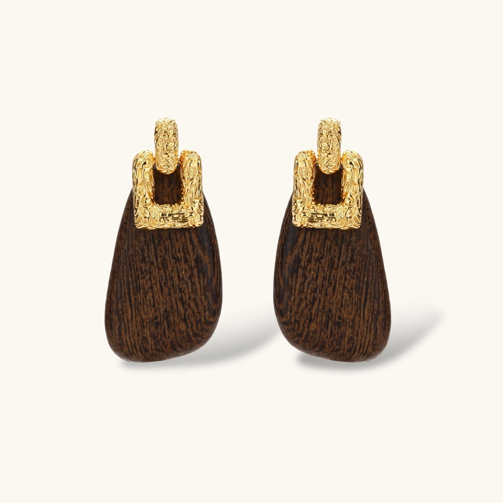 Elegant drop earrings featuring intricate 18k gold plated copper metalwork with dark brown wooden teardrop pendants