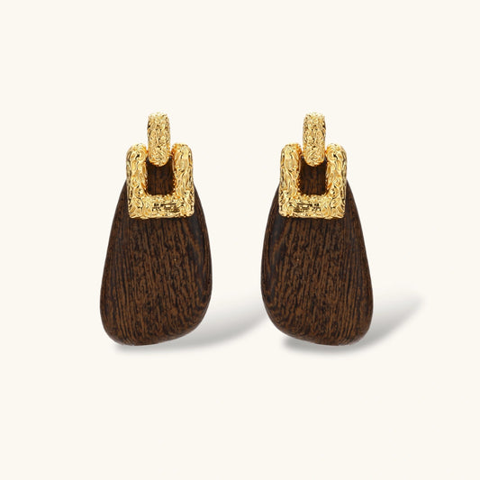 Elegant drop earrings featuring intricate 18k gold plated copper metalwork with dark brown wooden teardrop pendants