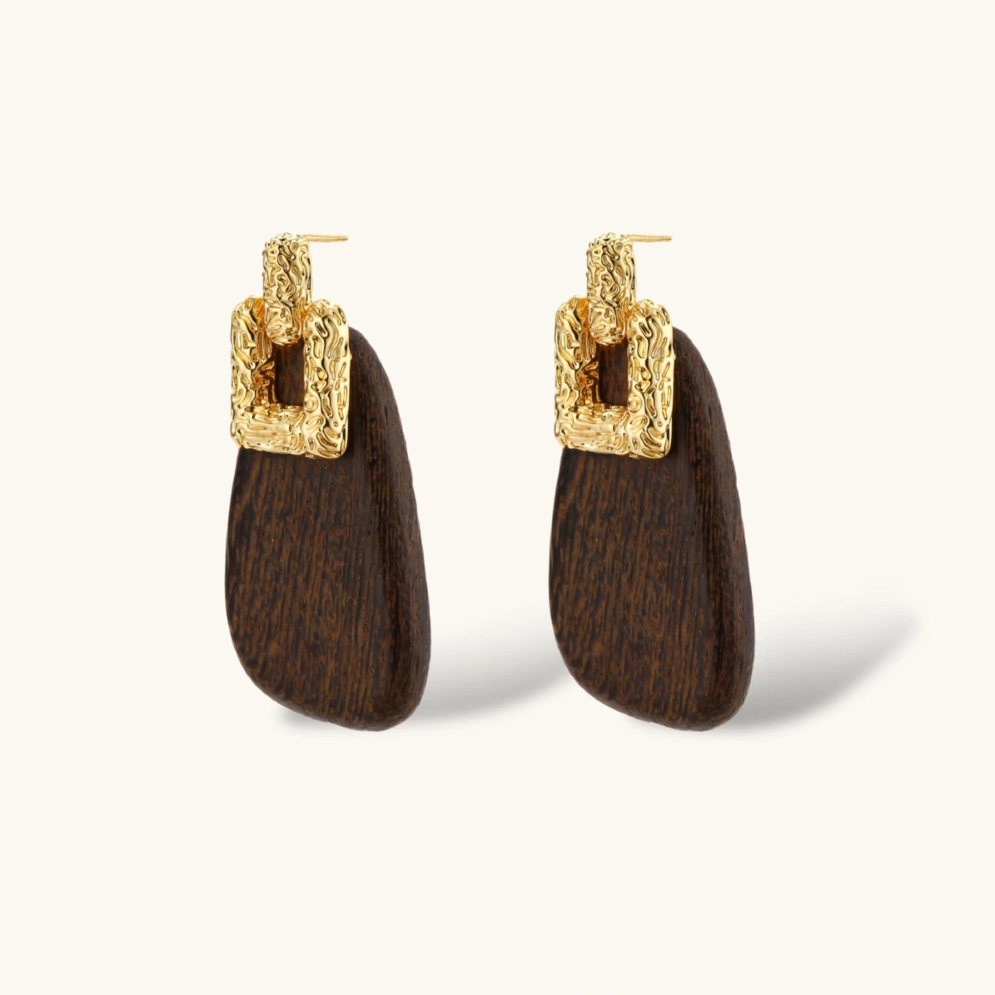 Elegant drop earrings featuring intricate 18k gold plated copper metalwork with dark brown wooden teardrop pendants