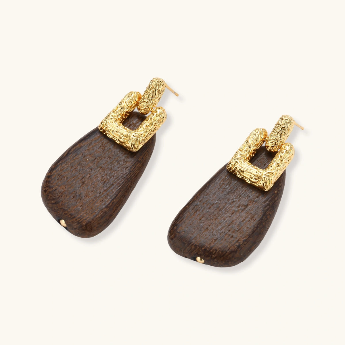 Elegant drop earrings featuring intricate 18k gold plated copper metalwork with dark brown wooden teardrop pendants