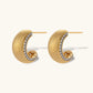 Small gold-plated hoop earrings with crystal accents and brushed finish on white background.