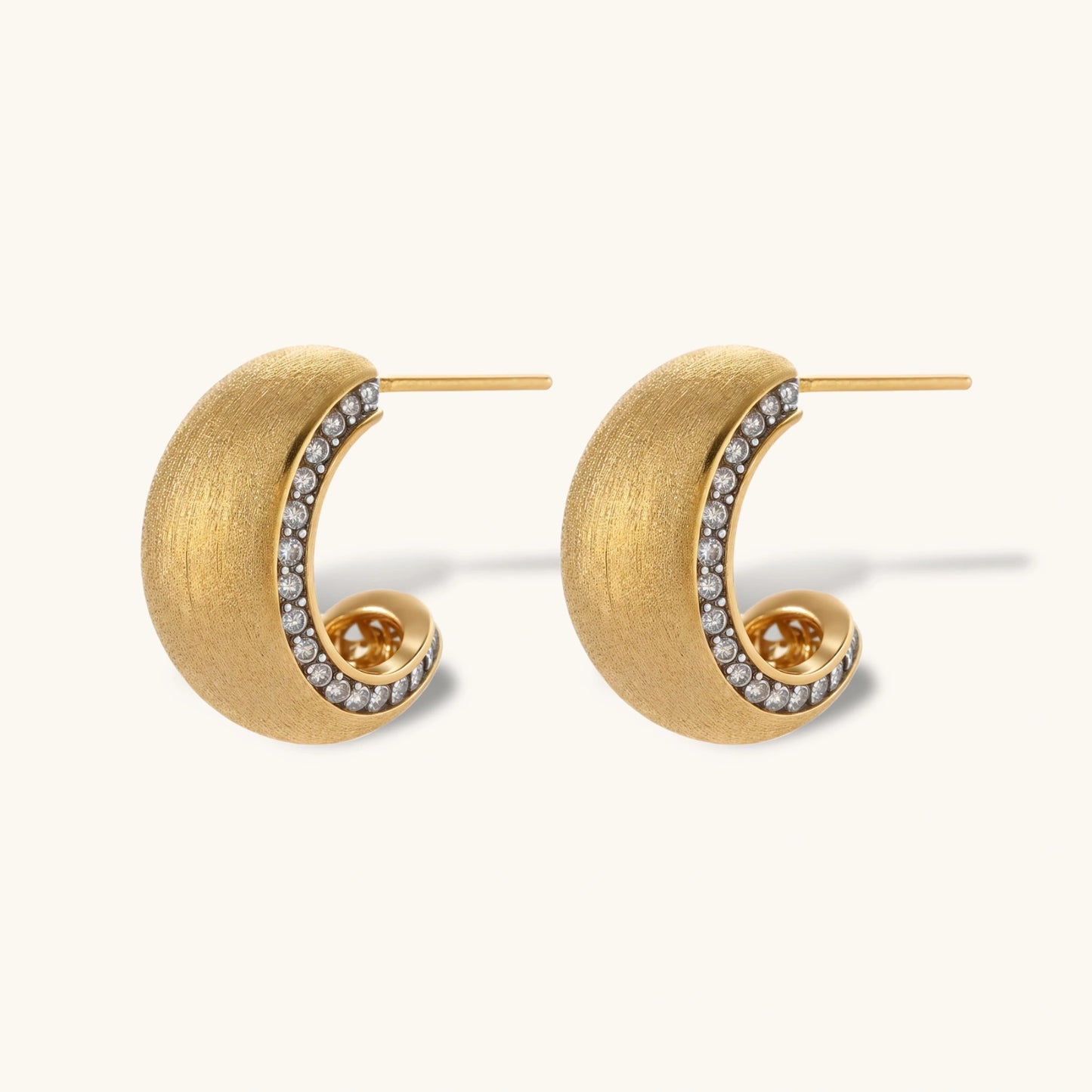 Small gold-plated hoop earrings with crystal accents and brushed finish on white background.